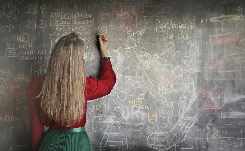 image of woman at chalkboard